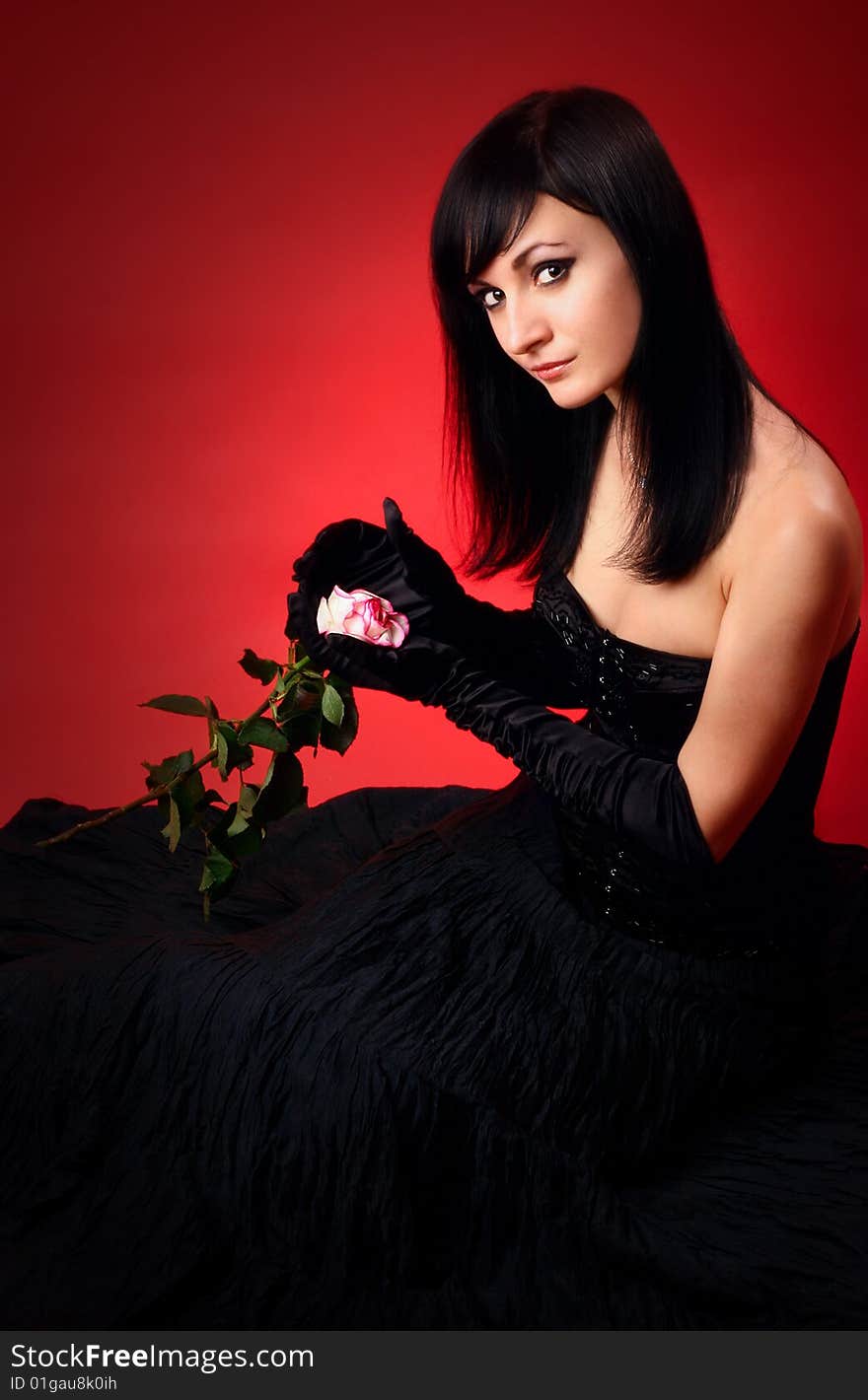 Beautiful brunette on a red background