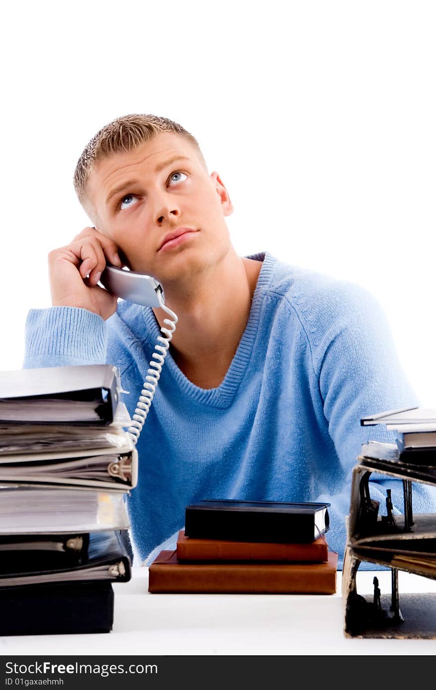 Man on phone in office with files