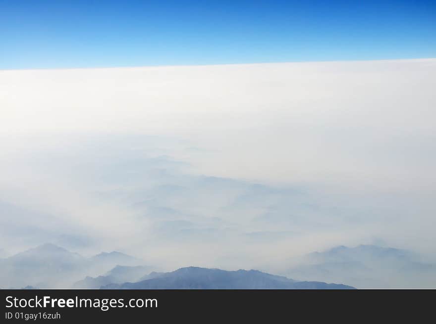 Mountain in clouds,seen from plane. Mountain in clouds,seen from plane