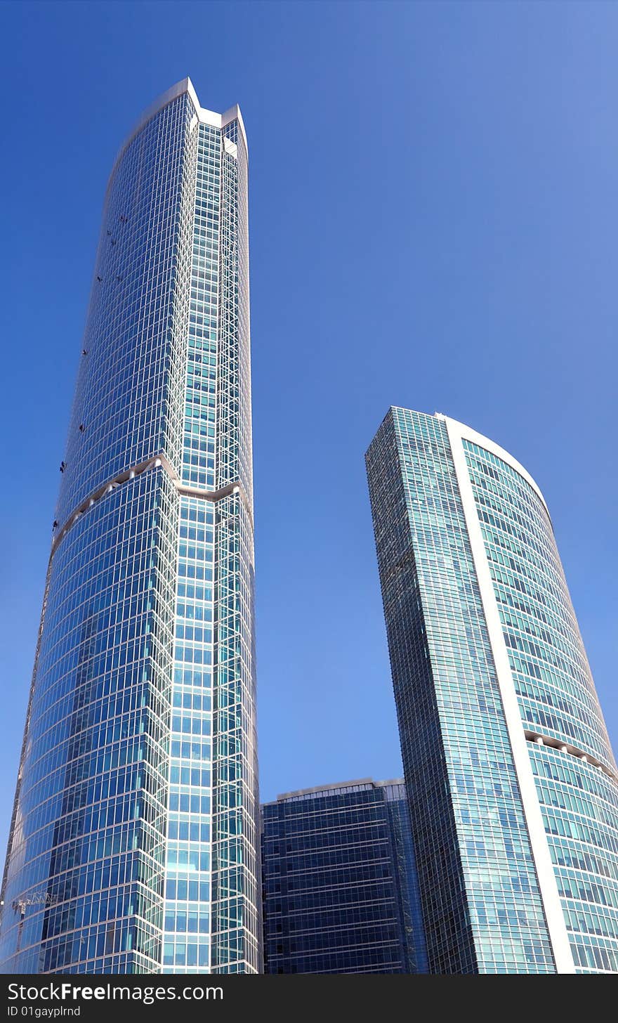 Business center under the blue sky with the sun.