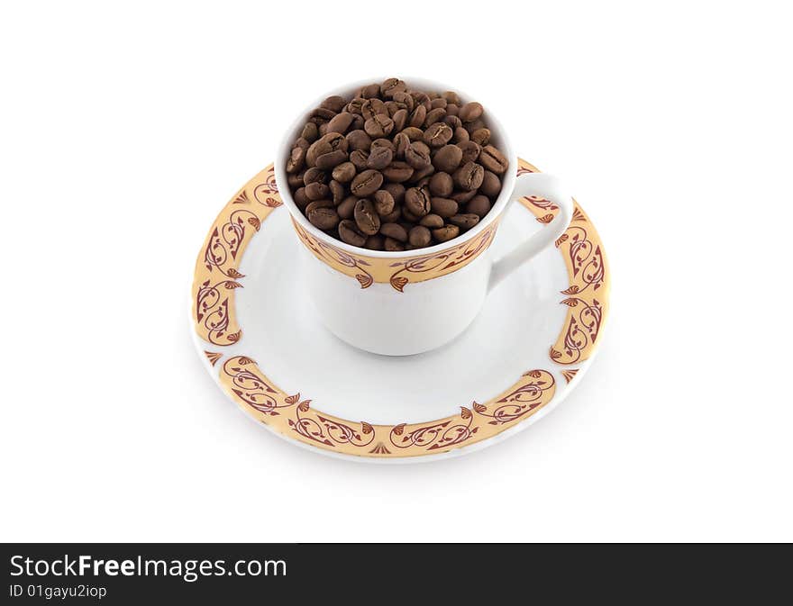 Cup with coffee beans isolated on white background