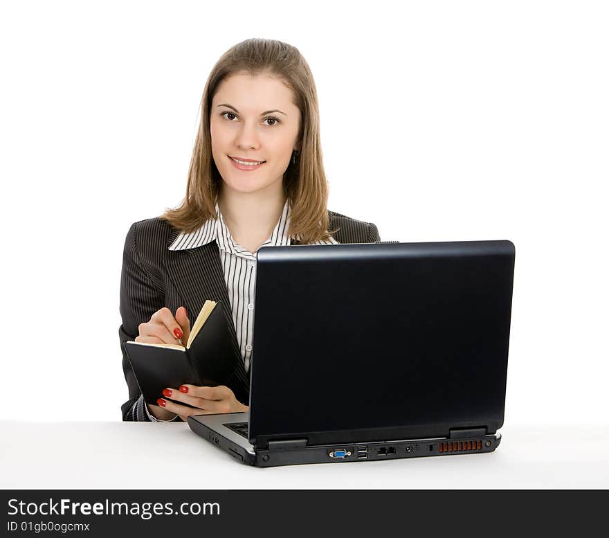 Beautiful young businesswoman working on a laptop. Isolated on white.