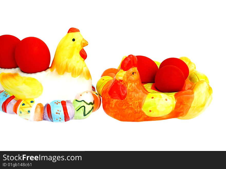 Easter red eggs on the hen and cock on white background.