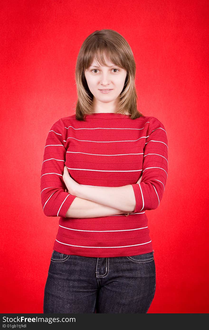 Studio shot of a pretty young woman on a red background. Studio shot of a pretty young woman on a red background