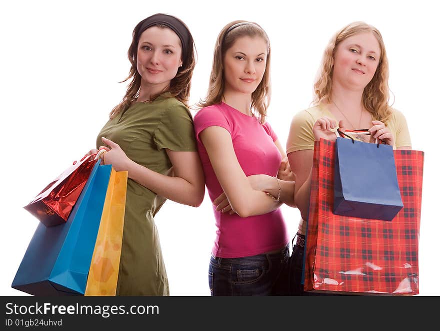 Three girls with shopping bags. Isolated on white