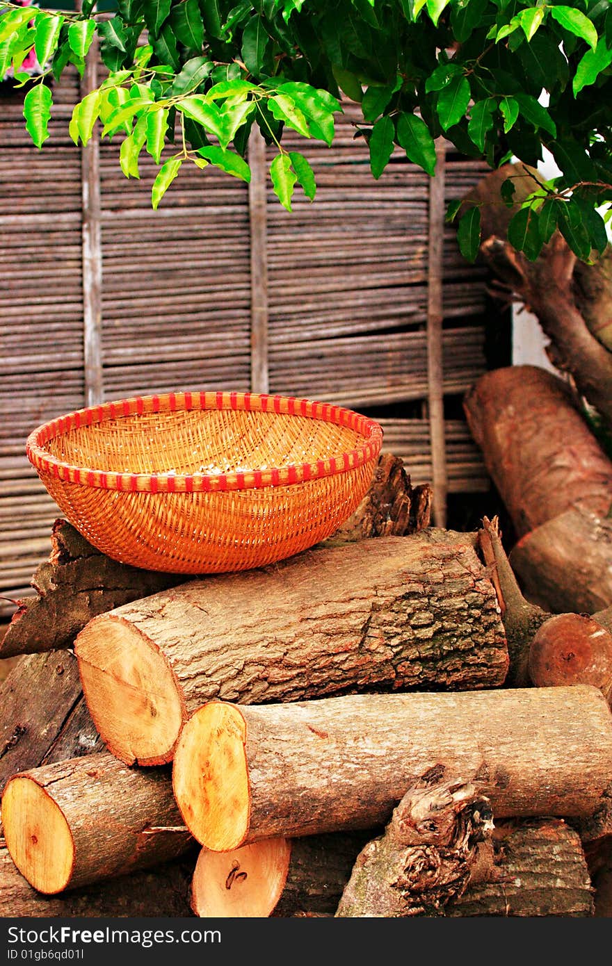 Reed basket on wooden logs shot in vietnam