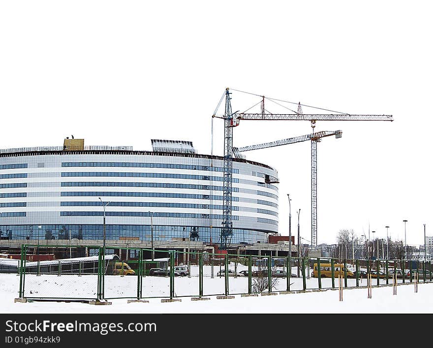 Building with lifting crane in winter