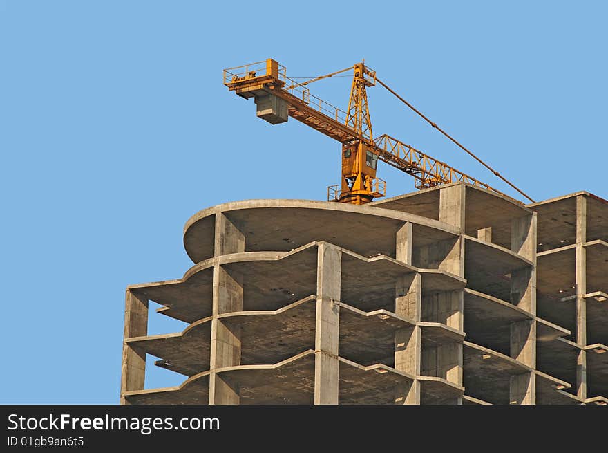 View of monolithic housebuilding with crane. View of monolithic housebuilding with crane