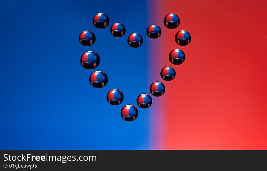 Water drops in the form of heart on a celebratory background