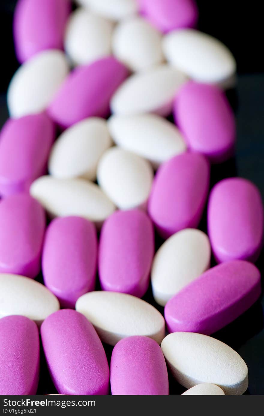 Colored oblong pills on the isolated background