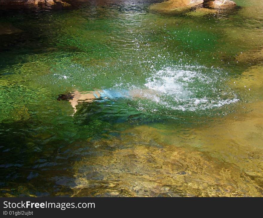 Boy swiming in a clear water pond. Boy swiming in a clear water pond