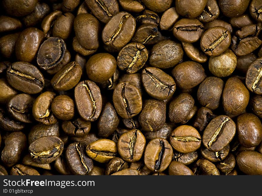 Background from the spilled grains of Brazilian coffee