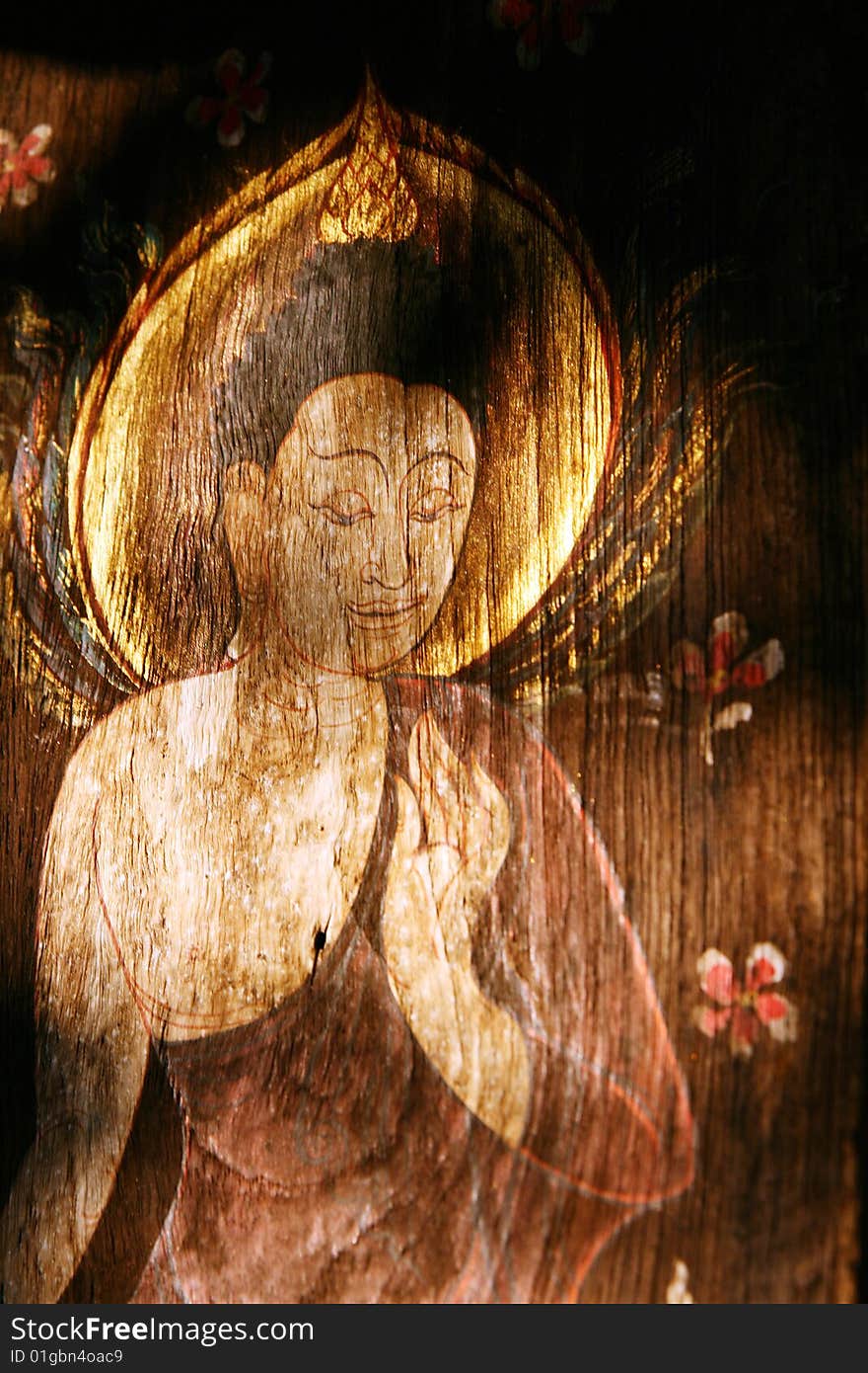 The painting of buddha on the wood wall in temple. The painting of buddha on the wood wall in temple.