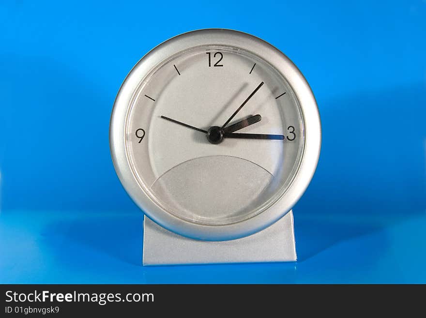 Simple gray desk clock (on a bright blue background)