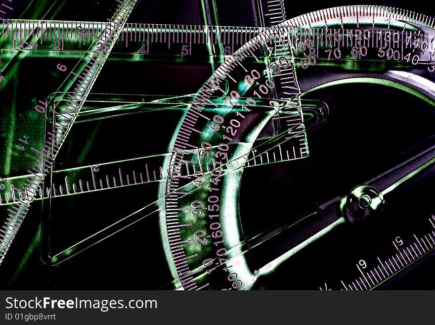 Transparent rulers and protractors against a black background (as an abstract mathematical background)