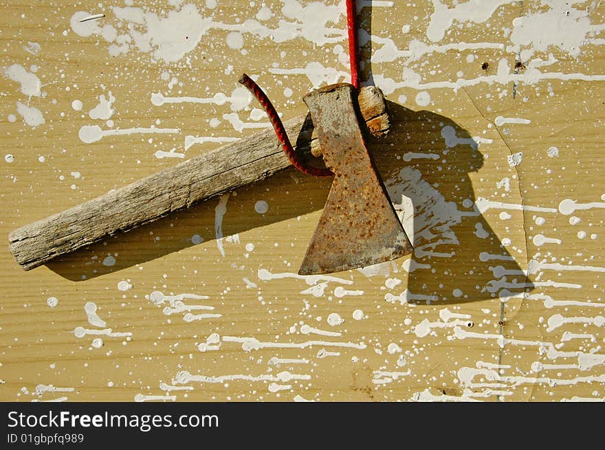 Rusty axe in the sun over a dirty background