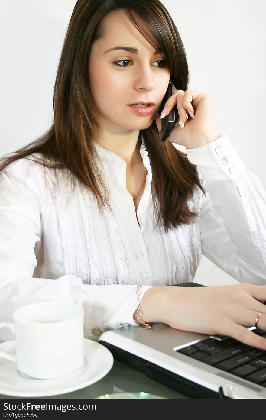 Business woman talks on a mobile telephone. Business woman talks on a mobile telephone