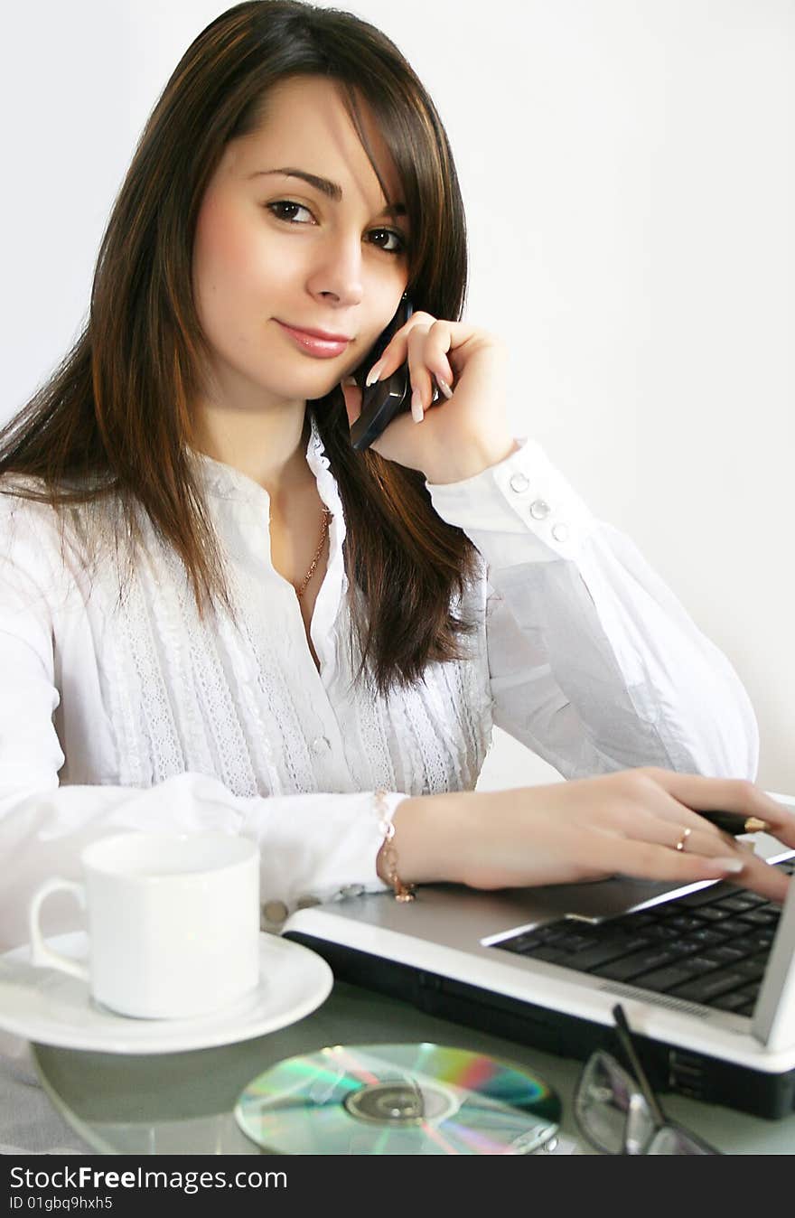 Business woman talks on a mobile telephone. Business woman talks on a mobile telephone