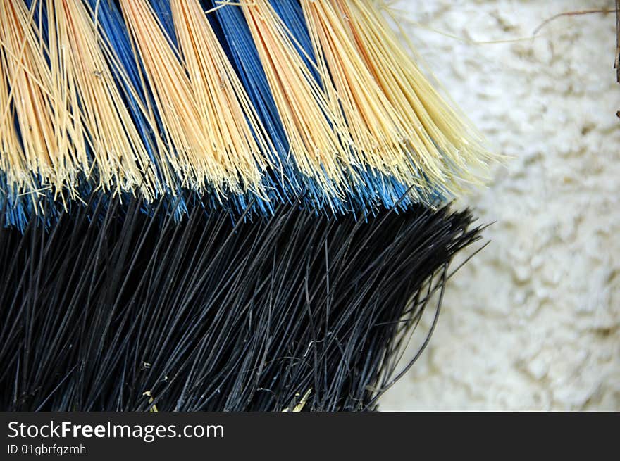 Detail of a beige and ble broom