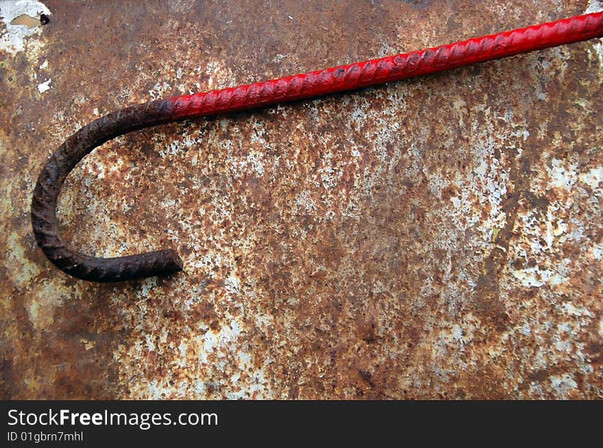 Red rusty rod folded as a hook