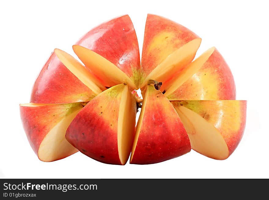 An apple is cut by lobules on a white background. An apple is cut by lobules on a white background.