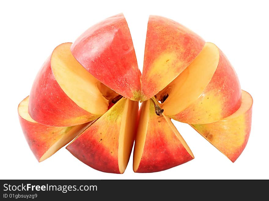 An apple is cut by lobules on a white background. An apple is cut by lobules on a white background.