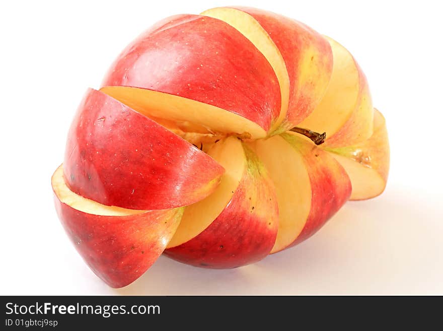 An apple is cut by lobules on a white background. An apple is cut by lobules on a white background.