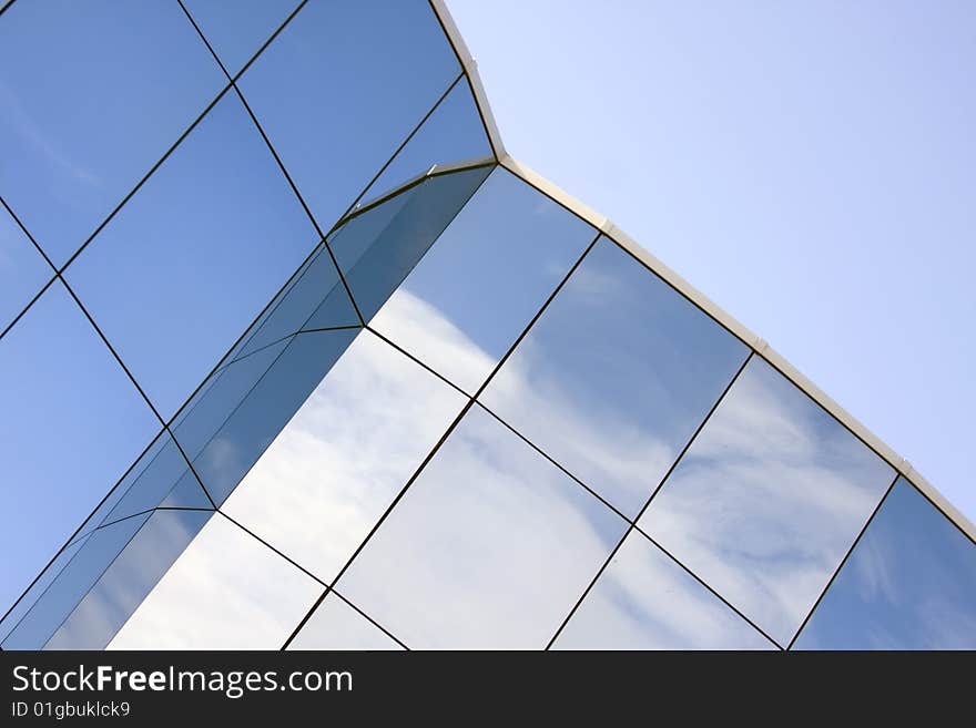 Reflections in the glass of the modern building. Reflections in the glass of the modern building.