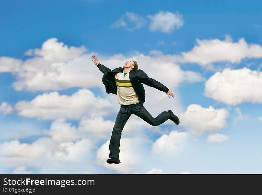 Jumping man over sky background