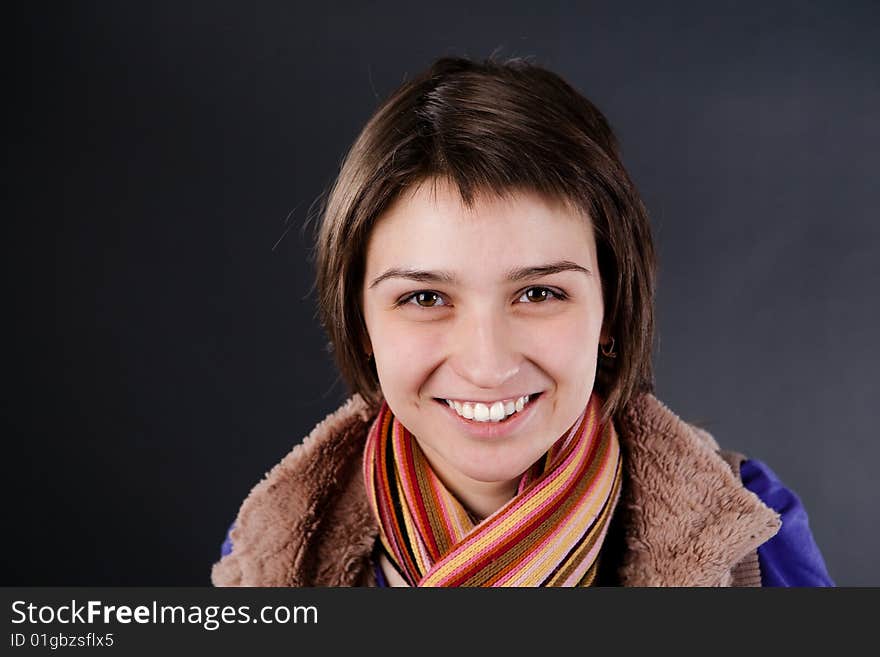 The cheerful woman is photographed in the studio