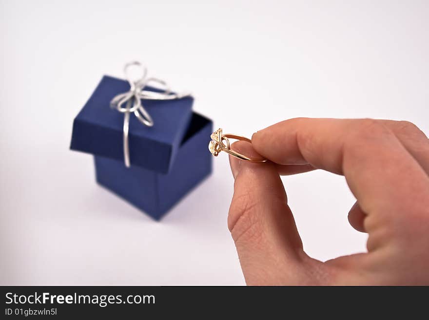 Engagement ring in man's hand.