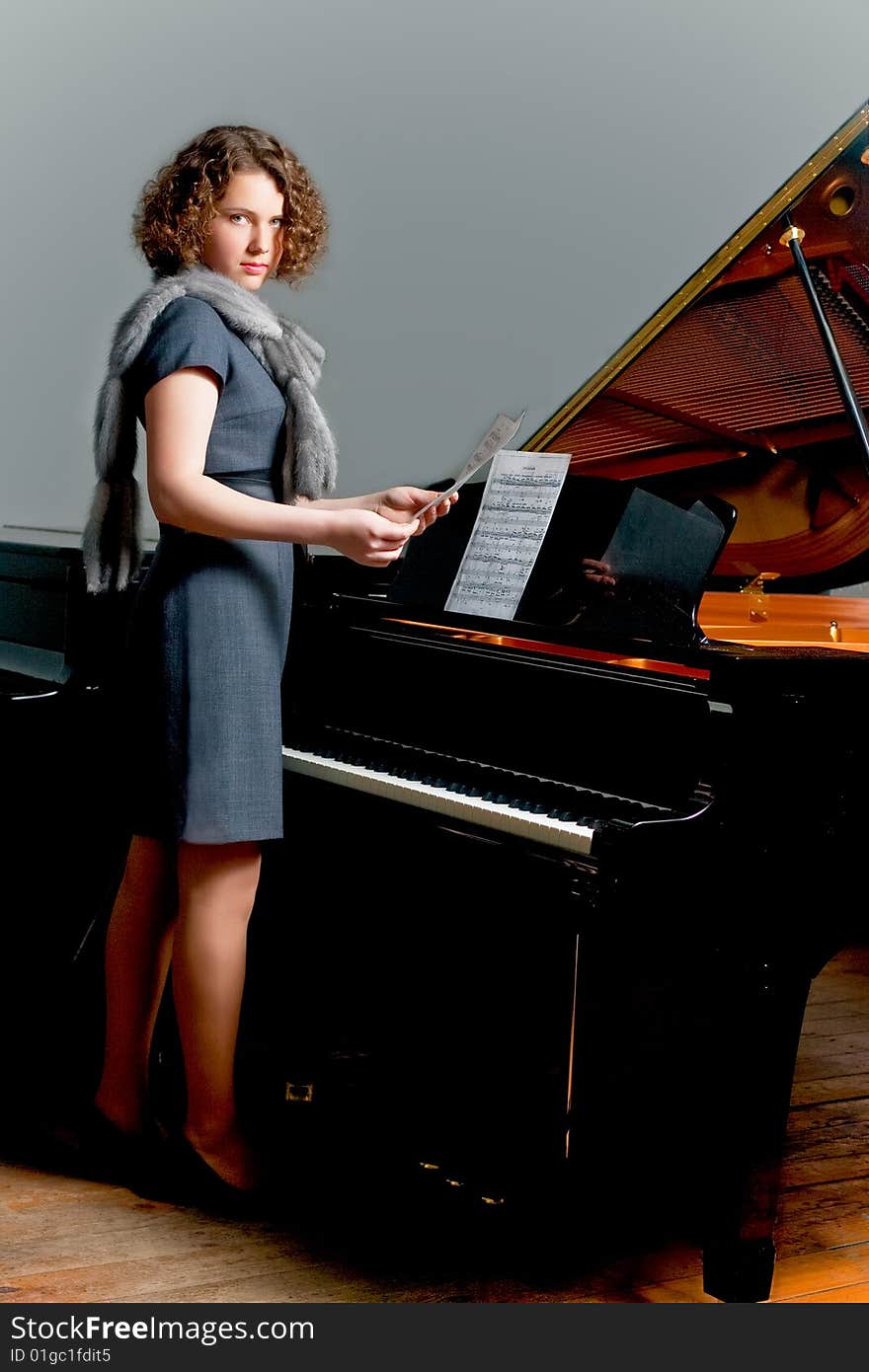 Young Girl Standing Near Piano