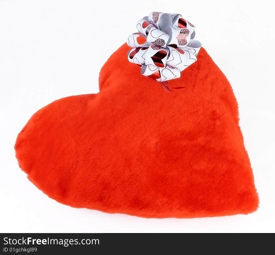 Closed-up Red pillow as a heart with bow on it isoleted on a white background. Closed-up Red pillow as a heart with bow on it isoleted on a white background