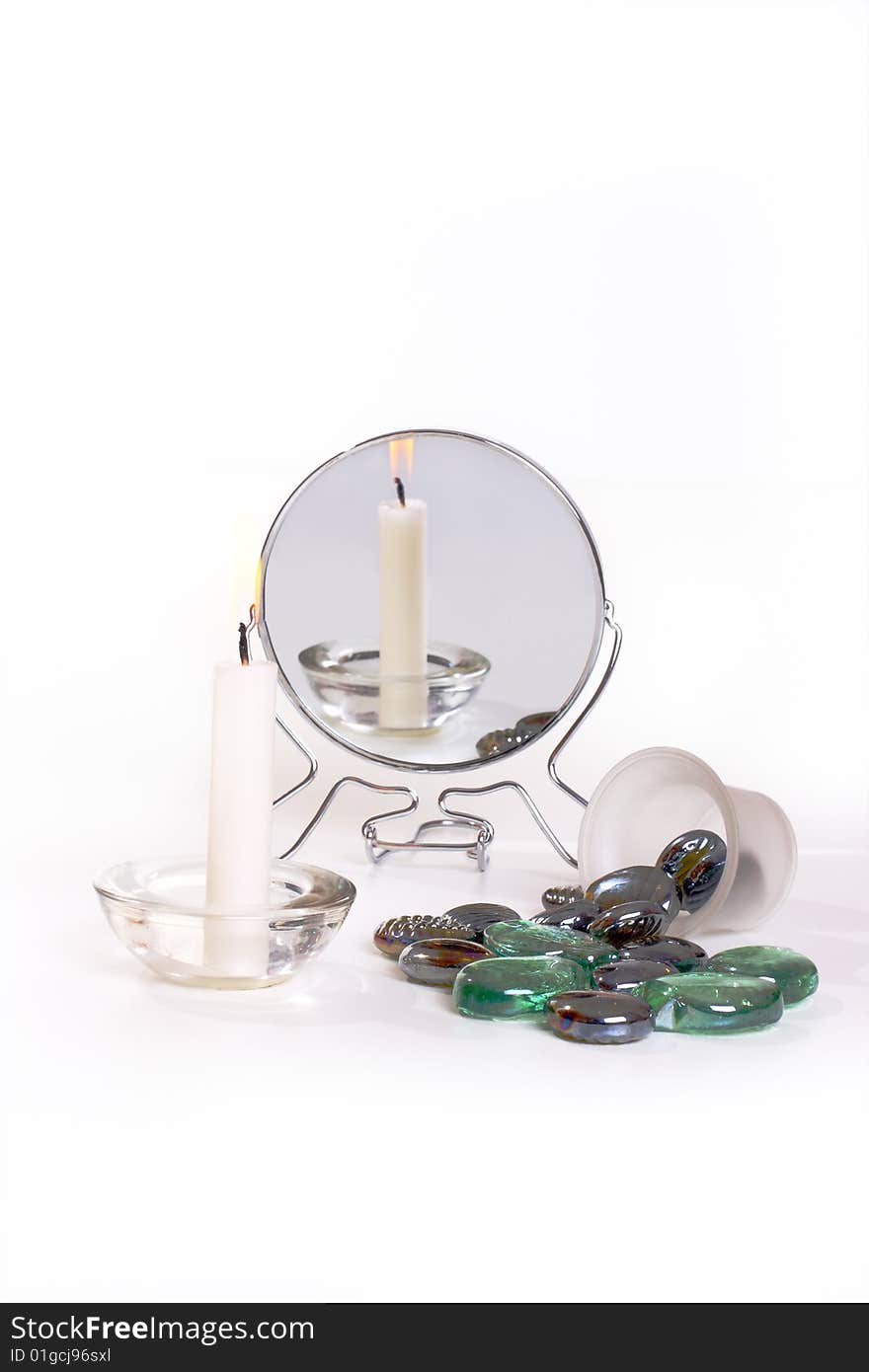 Reflection candles and stone in the mirror on the white background. Reflection candles and stone in the mirror on the white background