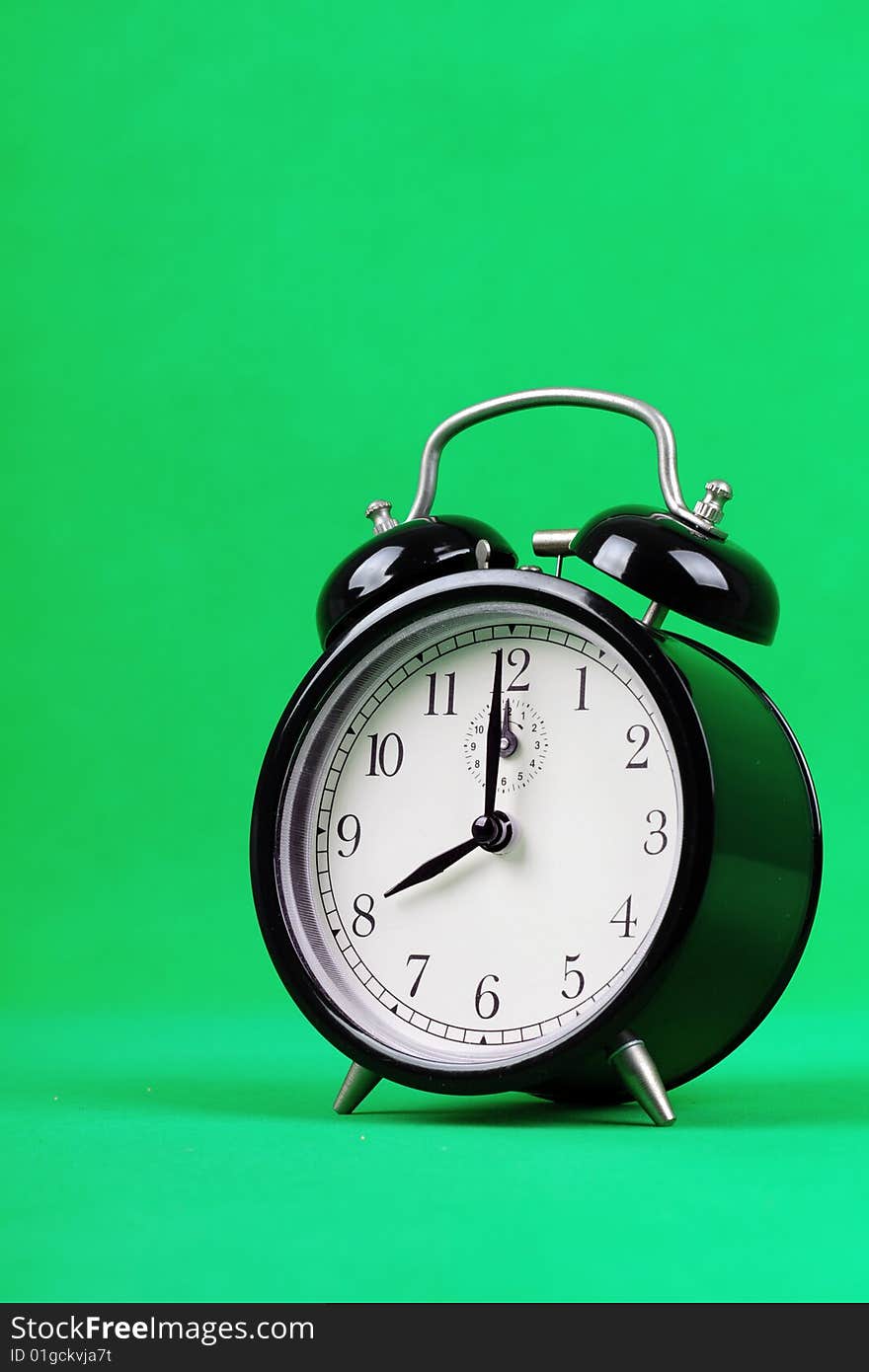 An alarm clock with green background