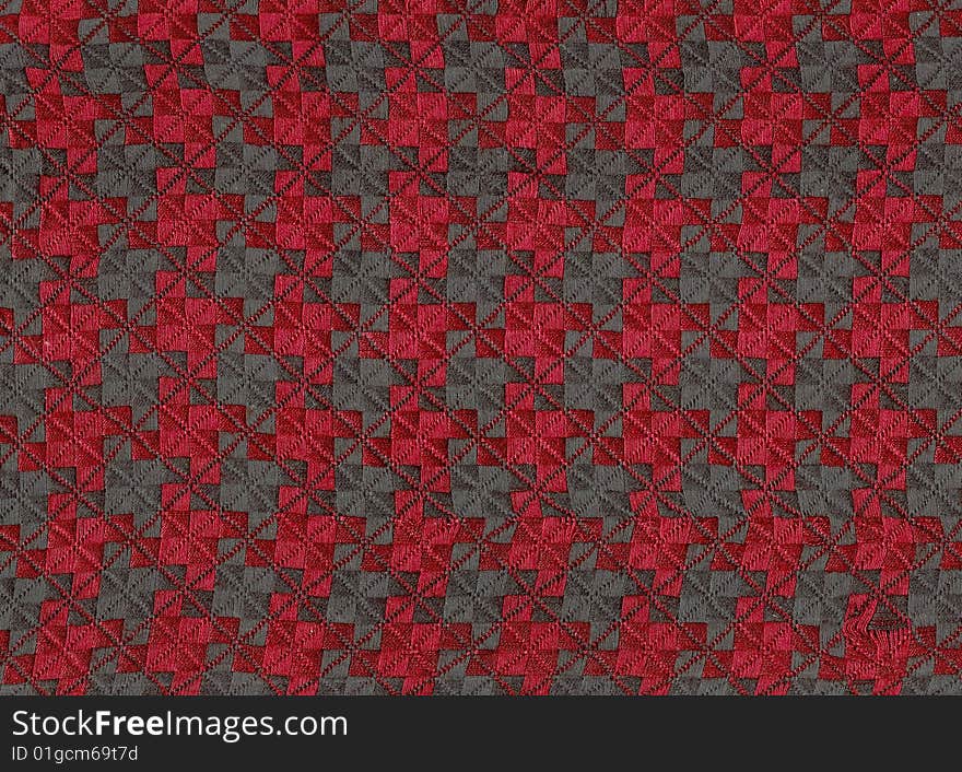 Clothe-up of a red and black houndstooth chek fabric. Clothe-up of a red and black houndstooth chek fabric