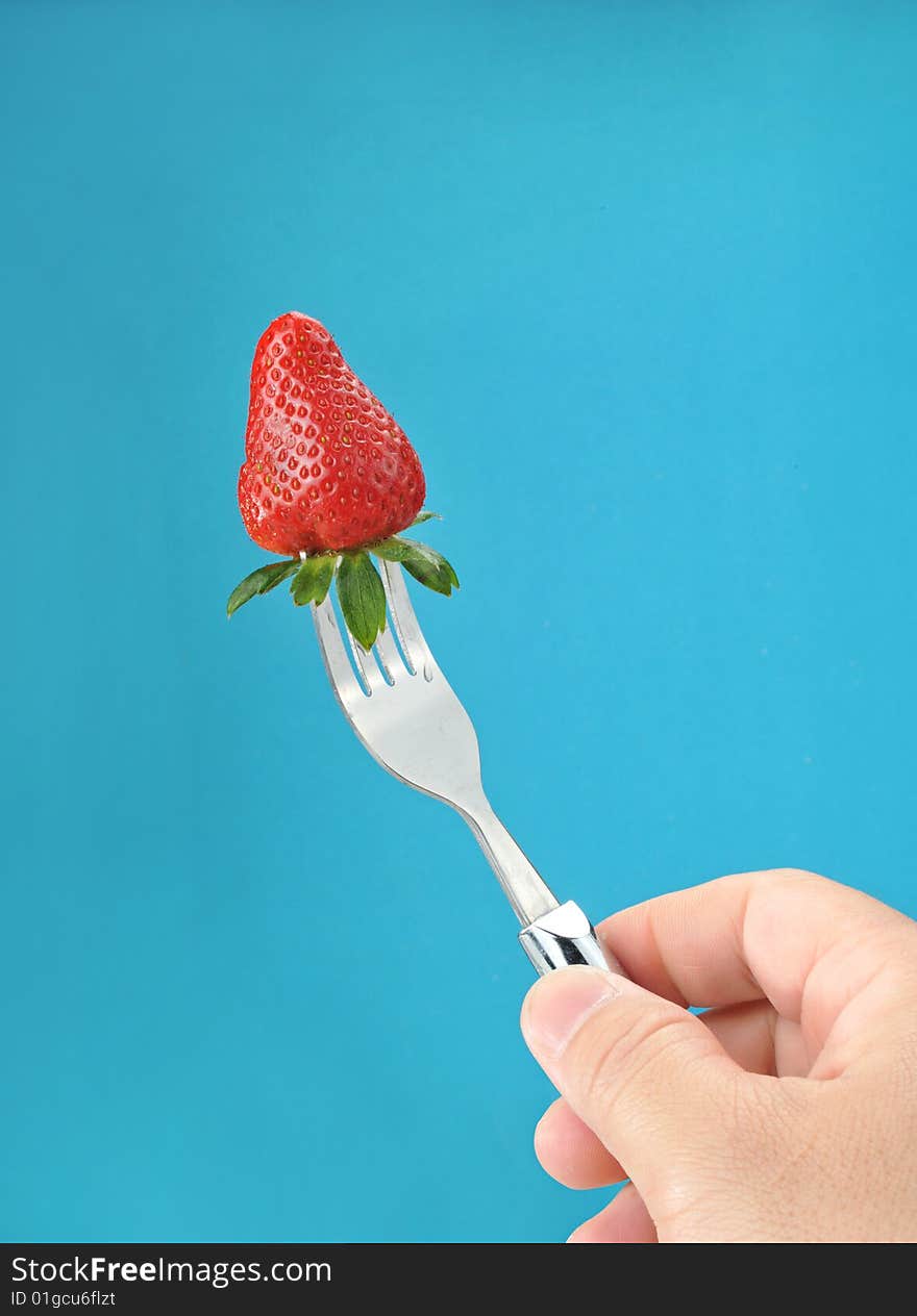 A fresh strawberry on a fork