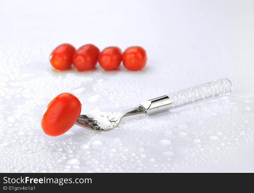 Small tomato on white background. Small tomato on white background.