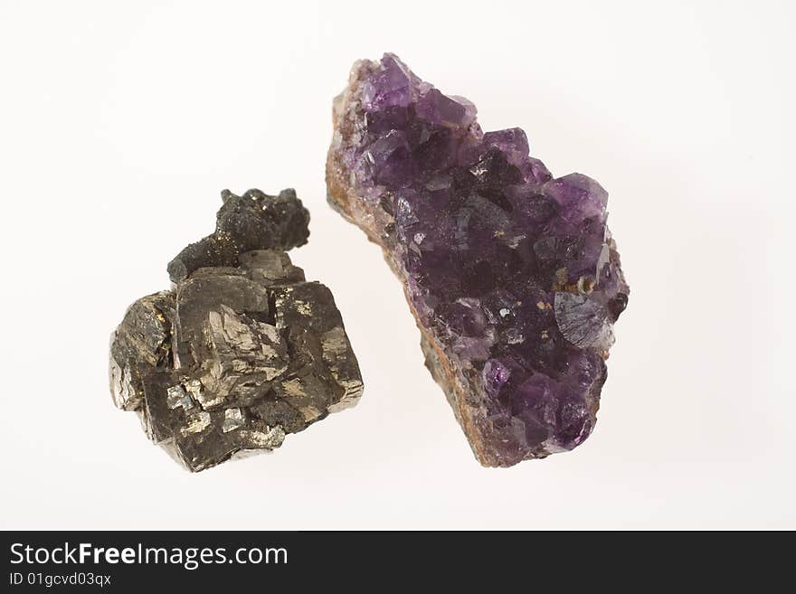 Two stones - pyrite and amethyst on white background