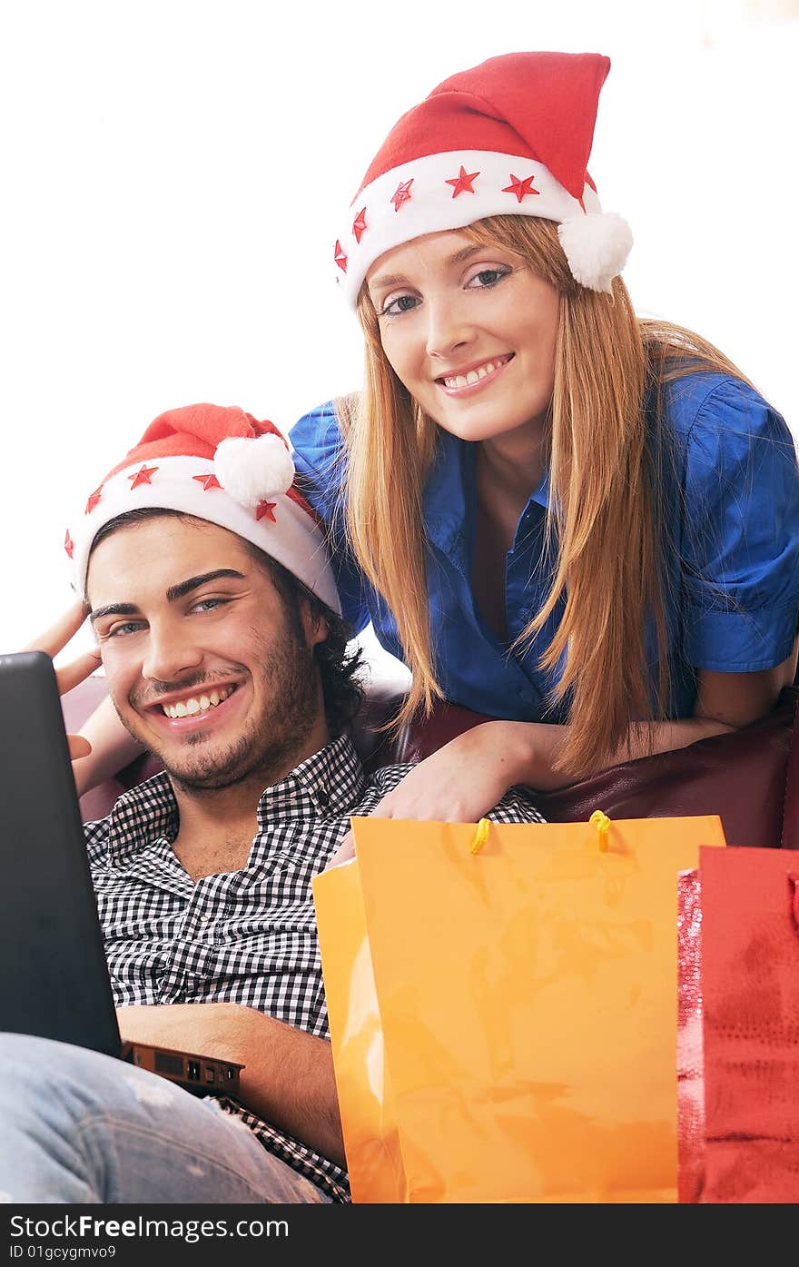 Young couple in Christmas on-line shopping on white background