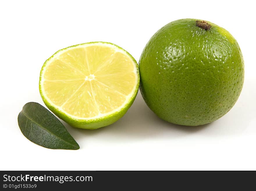 Green lime with leaf isolated on white