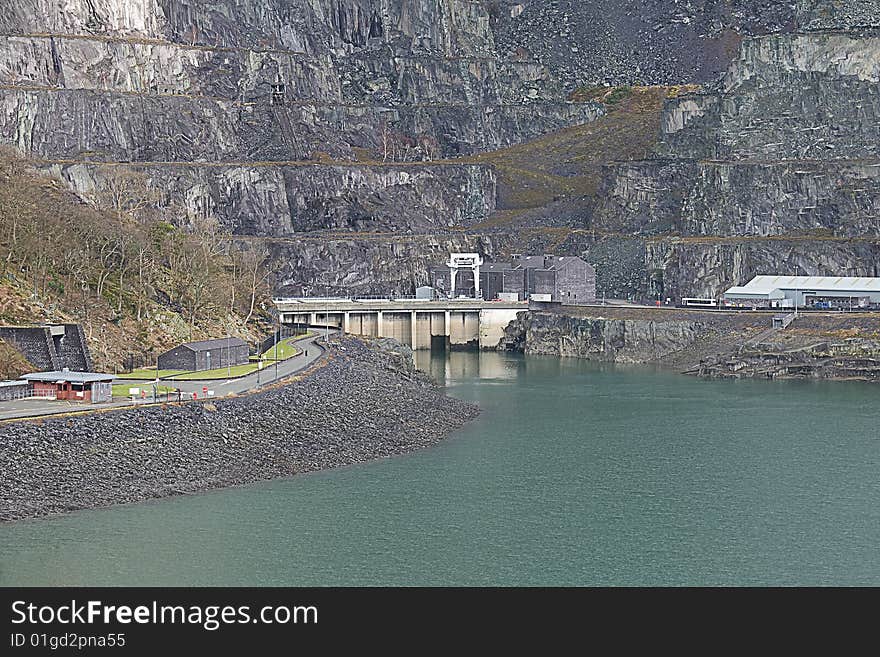 Abandoned buildings in a disused slate quarry in North Wales with a rugged mountain background. Abandoned buildings in a disused slate quarry in North Wales with a rugged mountain background.