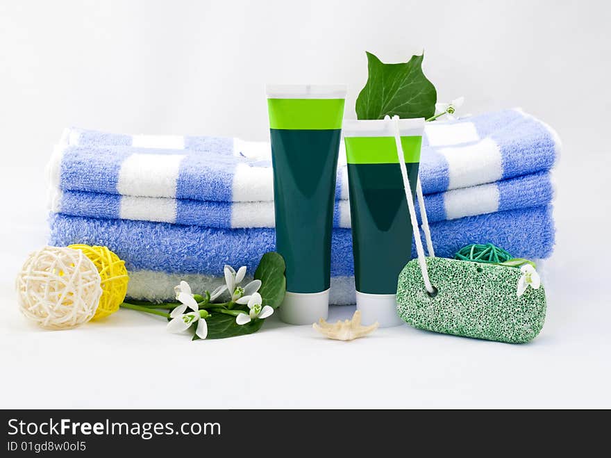 Striped towels with creams and snowdrops isolated on white background