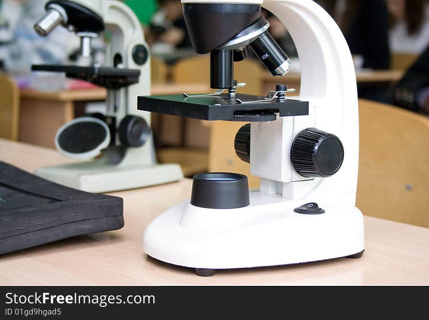 Two white optical microscopes close-up. Color shot. Old and modern micrscopes. Two white optical microscopes close-up. Color shot. Old and modern micrscopes.