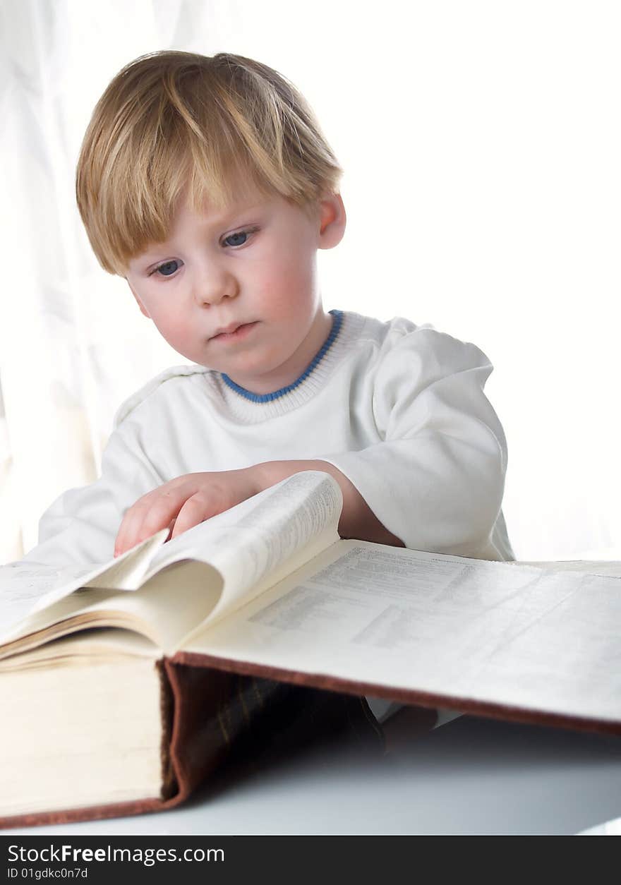 The boy with the big book in hands. The boy with the big book in hands