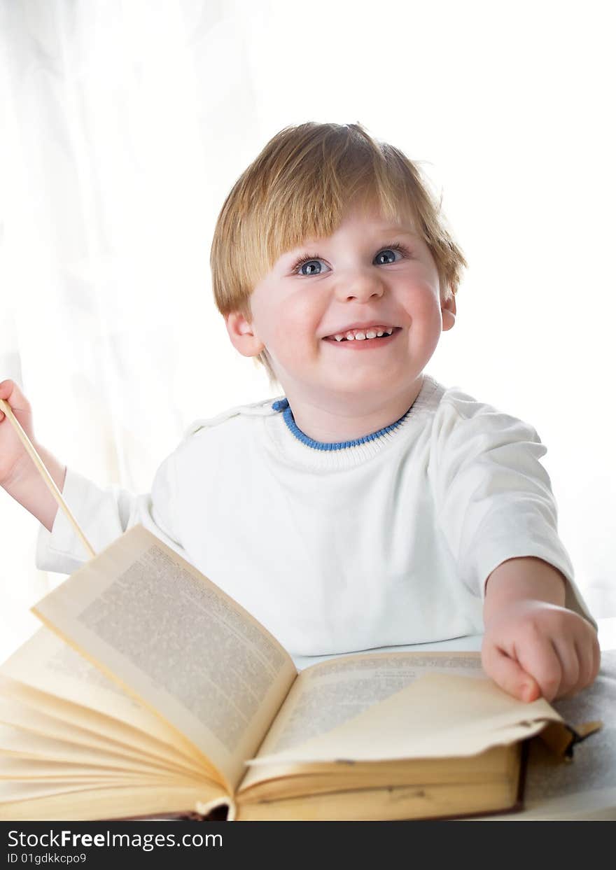 The boy with the big book in hands. The boy with the big book in hands