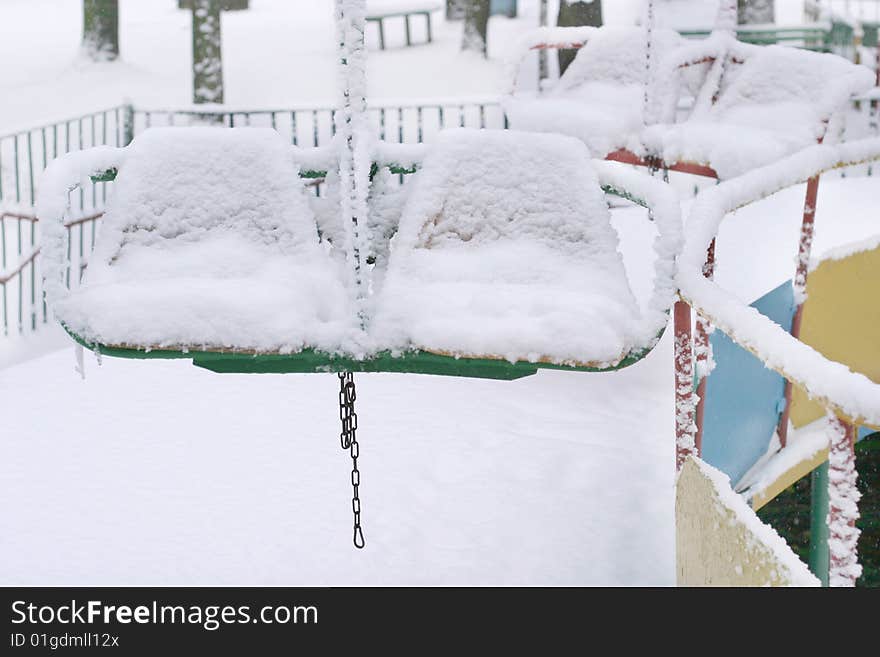 Winter scene with snowy chairs