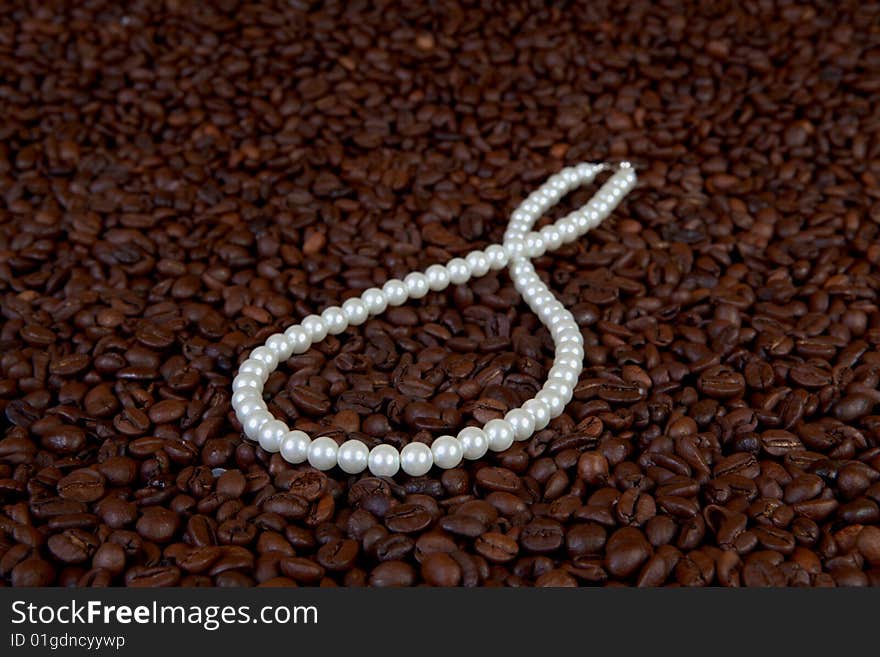 Pearl beads in coffee beans