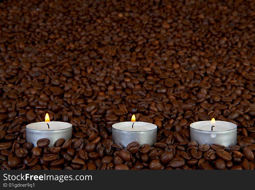 Thre candles in coffee beans