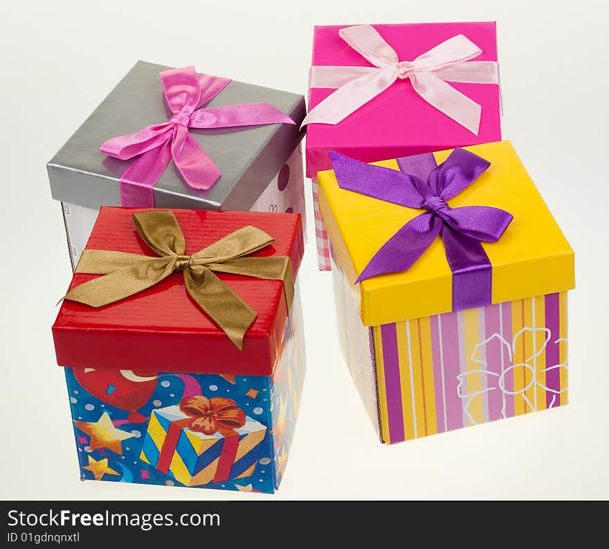 Various gift boxes on a white background, with bow